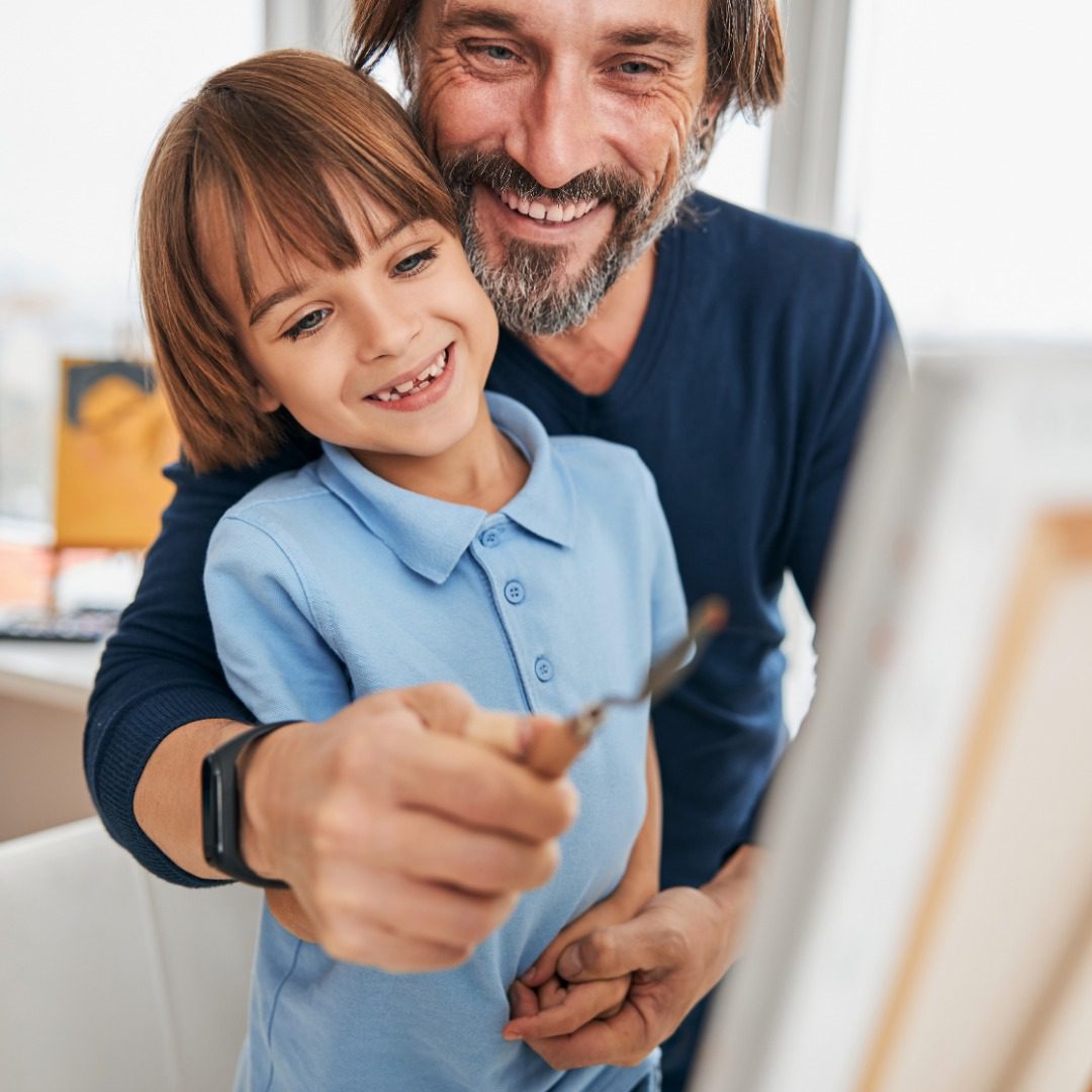 Happy dad and his son having arts and crafts time